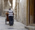 Bread Vendor Pushing His Cart in an alleyway of the Christian Quarter, Jerusalem, Israel Royalty Free Stock Photo