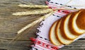 Bread and wheat ears on a wooden surface. Royalty Free Stock Photo