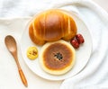 bread in a white clean plate. Bright Japanese style breakfast food photography.