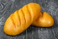 Bread white loaf of wheat flour with incisions on a wooden background Royalty Free Stock Photo