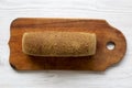 Bread on wooden cutting board on white woodem background. Royalty Free Stock Photo