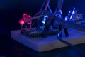 breadboard arduino nano prototyping board transistors resistors LEDs red and blue in glow in the dark on black skin Royalty Free Stock Photo