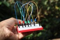 Breadboard circuit with jumper cables and different colored LED connected to each other for some electronic project prototyping Royalty Free Stock Photo