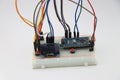 Breadboard circuit made from display module and microcontroller board connected with wires shows concept of innovative stem