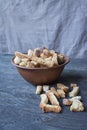 Breadcrumbs in a bowl. Sliced bread crumbs. Grey background. Side view