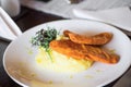 Breaded chicken fillet with mashed potato and rucola leaf.