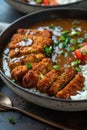 Breaded chicken katsu with curry sauce over rice in a bowl