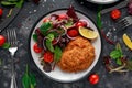 Breaded Chicken Kiev breast stuffed with butter, garlic and herbs served with vegetables in a plate. Royalty Free Stock Photo