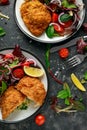 Breaded Chicken Kiev breast stuffed with butter, garlic and herbs served with vegetables in a plate. Royalty Free Stock Photo