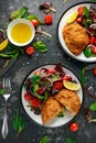 Breaded Chicken Kiev breast stuffed with butter, garlic and herbs served with vegetables in a plate. Royalty Free Stock Photo