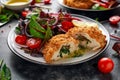 Breaded Chicken Kiev breast stuffed with butter, garlic and herbs served with vegetables in a plate.