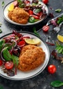 Breaded Chicken Kiev breast stuffed with butter, garlic and herbs served with vegetables in a plate. Royalty Free Stock Photo