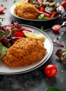 Breaded Chicken Kiev breast stuffed with butter, garlic and herbs served with vegetables in a plate. Royalty Free Stock Photo