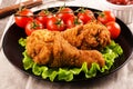 Breaded chicken legs with tomatoes