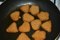 Breaded chicken nuggets are fried in a frying pan Royalty Free Stock Photo