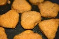 Breaded chicken nuggets are fried in a frying pan Royalty Free Stock Photo