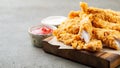 Breaded chicken strips with two kinds of sauces and fried potatoes on a wooden Board. Fast food on dark brown background. with cop Royalty Free Stock Photo