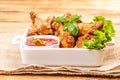 Breaded chicken wings.Fried breaded chicken wings with lettuce and with ketchup on a wooden background. fast food, close-up Royalty Free Stock Photo