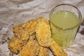 Breaded chicken wings and a glass of lemonade on a grey paper background. Close up Royalty Free Stock Photo