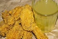 Breaded chicken wings and a glass of lemonade on a grey paper background. Close up Royalty Free Stock Photo