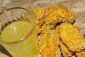 Breaded chicken wings and a glass of lemonade on a grey paper background. Close up Royalty Free Stock Photo