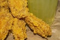 Breaded chicken wings and a glass of lemonade on a grey paper background. Close up Royalty Free Stock Photo