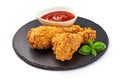 Breaded crispy fried chicken legs with ketchup, isolated on white background