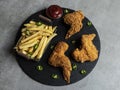 Breaded crispy fried chicken  wings, french fries and sauce Royalty Free Stock Photo