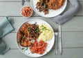 Breaded cutlet with roasted onions, mashed potatoes and tomato salad on a plate Royalty Free Stock Photo