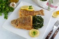 Deep Fried Breaded Whole Fish with Sauteed Greens Royalty Free Stock Photo