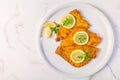 Breaded fish, baked and served with lemon. Common dab, edible flatfisch