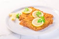 Breaded fish, baked and served with lemon. Common dab, edible flatfisch