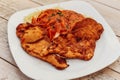 Breaded and fried chicken breast dish, accompanied by spaghetti with tomato Royalty Free Stock Photo