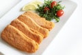 Breaded and fried fish fillets with salad and lemon. Royalty Free Stock Photo