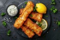 Breaded and fried fish fingers served with remoulade sauce and lemon Royalty Free Stock Photo