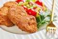 Breaded lamb chops served on a plate Royalty Free Stock Photo