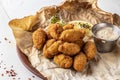 Breaded mussels, lemon and sauce, beer snack, horizontal photo