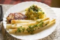 Breaded pork chops with white asparagus and mashed potatoes