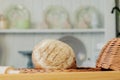 Breads near a wicker basket on a table in a rustic kitchen. Composition in kitchen at the photo studio Royalty Free Stock Photo