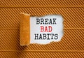 Break bad habits symbol. Words `Break bad habits` appearing behind torn brown paper. Beautiful brown background. Business,