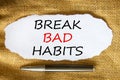 Break bad habits symbol. Words `Break bad habits` on white paper. Black metallic pen. Beautiful canvas background. Business,