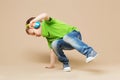 break dance kids. little break dancer showing his skills in dance studio. Hip hop dancer boy performing over studio background Royalty Free Stock Photo