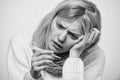 Break fever remedies. Take temperature and assess symptoms. Woman feels badly ill sneezing. Girl in scarf hold Royalty Free Stock Photo