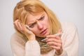 Break fever remedies. Take temperature and assess symptoms. Woman feels badly ill sneezing. Girl in scarf hold Royalty Free Stock Photo