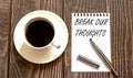 BREAK OUR THOUGHTS - white paper with pen and coffee on wooden background Royalty Free Stock Photo