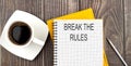 BREAK THE RULES text on the notebook with coffee on wooden background Royalty Free Stock Photo