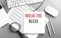 BREAK THE RULES text on notepad on chart with keyboard and calculator on grey background Royalty Free Stock Photo