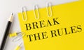 BREAK THE RULES word on the yellow paper with office tools on white background Royalty Free Stock Photo