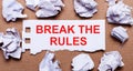 BREAK THE RULES written on white paper on a light brown background Royalty Free Stock Photo