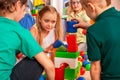 Break school of children playing in kids cubes indoor.